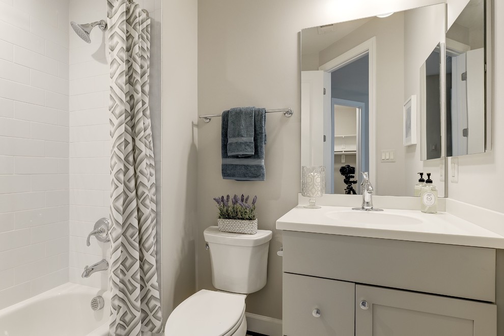 Alcove bathtub - mid-sized transitional 3/4 white tile and ceramic tile alcove bathtub idea in DC Metro with shaker cabinets, gray cabinets, a one-piece toilet, beige walls, an integrated sink and quartzite countertops