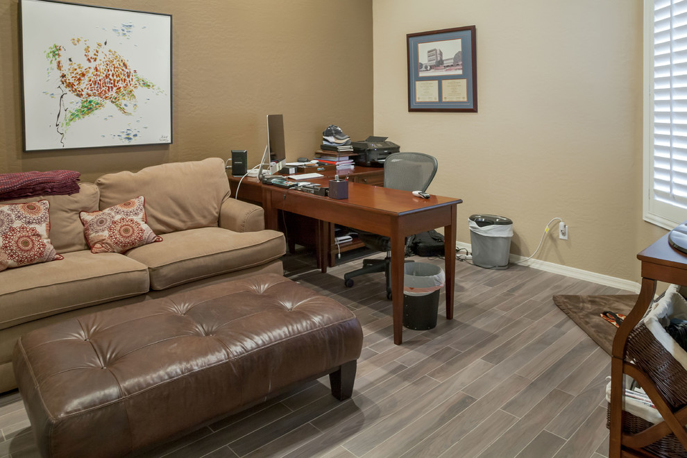 Transitional freestanding desk porcelain tile study room photo in Phoenix with beige walls