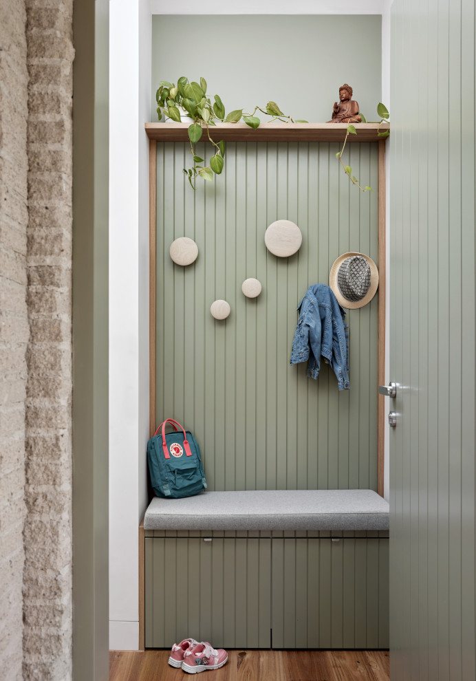 Inspiration for a mid-sized beach style entryway in Melbourne with white walls, medium hardwood floors, a single front door, a green front door and vaulted.
