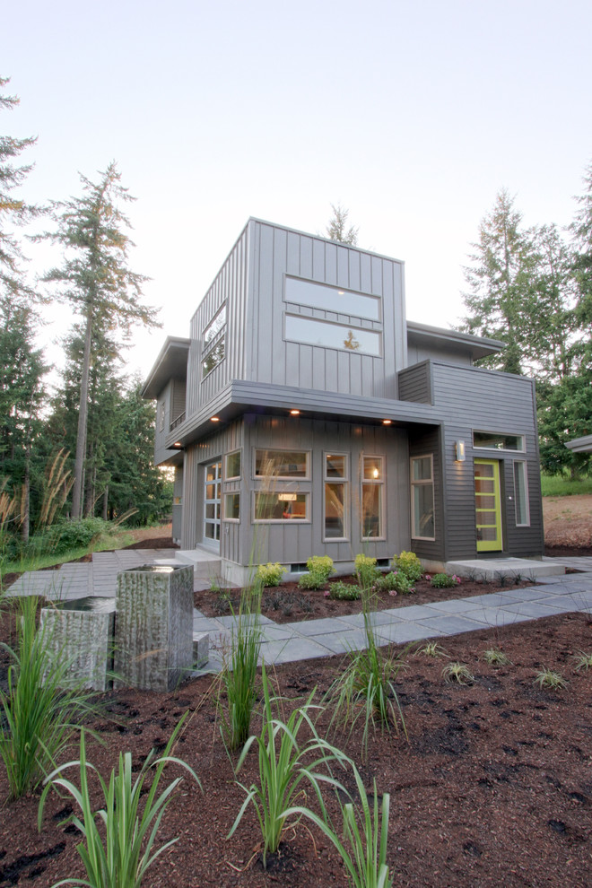 Design ideas for a mid-sized modern two-storey grey exterior in Portland with mixed siding and a flat roof.