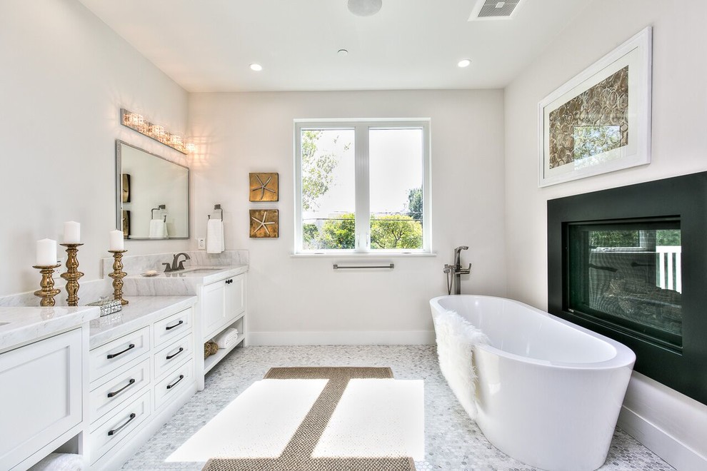 Mid-sized transitional master gray tile and marble tile gray floor and marble floor freestanding bathtub photo in Orange County with white cabinets, gray walls, an undermount sink, marble countertops and recessed-panel cabinets
