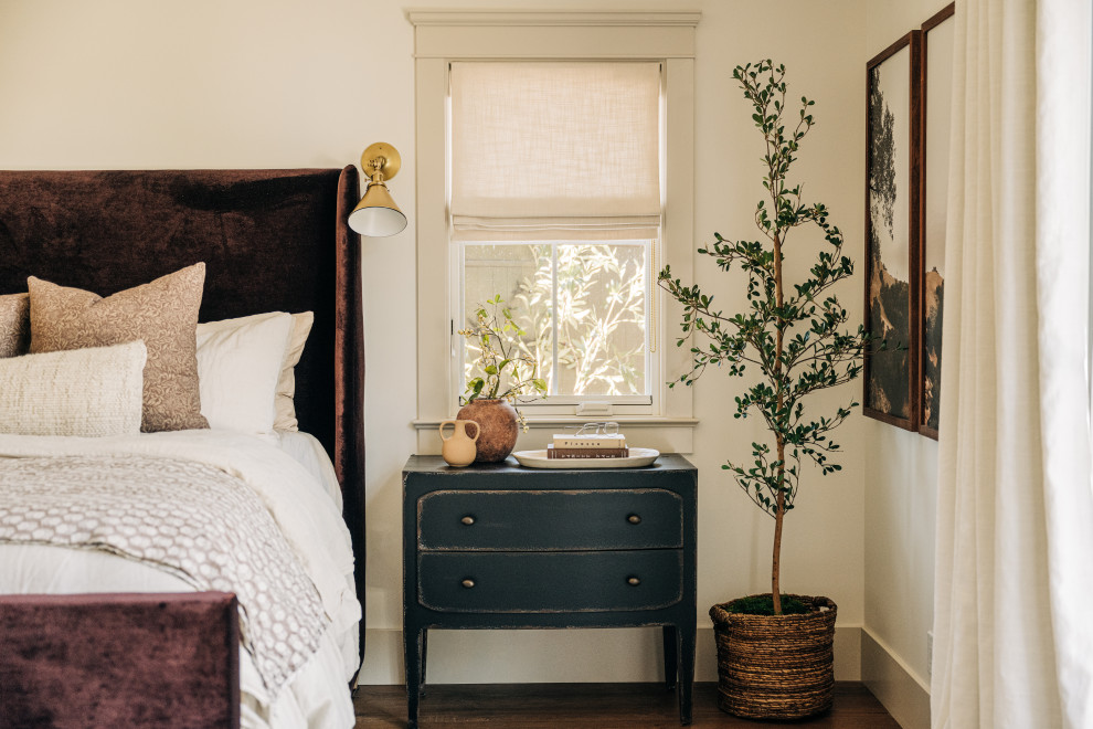 Transitional dark wood floor and brown floor bedroom photo in Los Angeles with beige walls