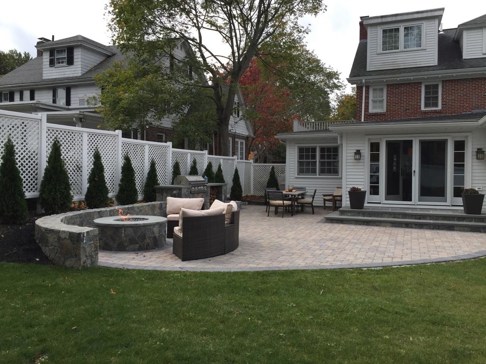 Mid-sized transitional backyard concrete paver patio photo in Orange County with a fire pit and no cover