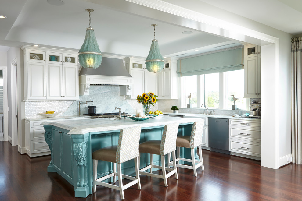 This is an example of a beach style l-shaped kitchen in Other with a farmhouse sink, raised-panel cabinets, white cabinets, stainless steel appliances, medium hardwood floors and with island.