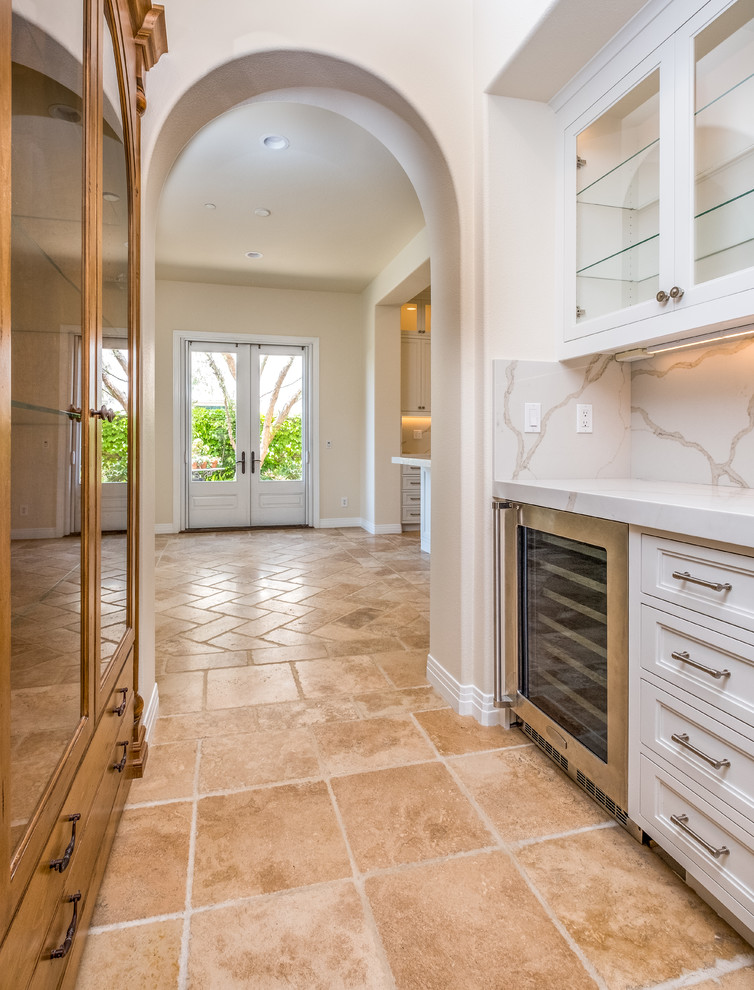 Inspiration for a mid-sized transitional porcelain tile and beige floor hallway remodel in Orange County with beige walls