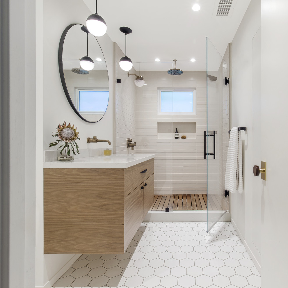 Midcentury bathroom in San Francisco with flat-panel cabinets, medium wood cabinets, an open shower, white tile, ceramic tile, ceramic floors, an integrated sink, granite benchtops, white floor, a hinged shower door, white benchtops, a single vanity and a floating vanity.