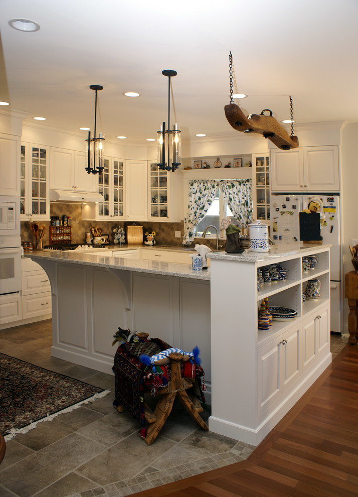 Eat-in kitchen - mid-sized transitional u-shaped porcelain tile eat-in kitchen idea with an undermount sink, flat-panel cabinets, white cabinets, granite countertops, stone tile backsplash, stainless steel appliances, a peninsula and multicolored backsplash