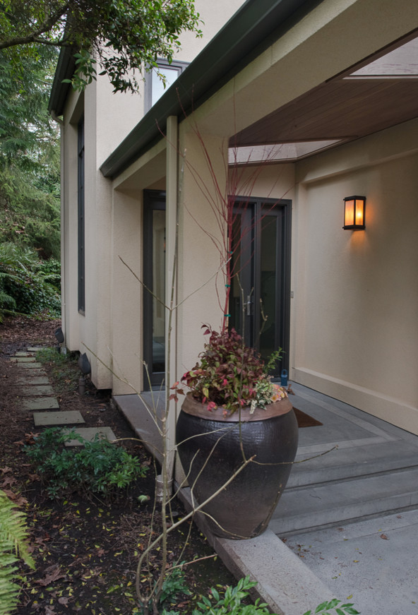 Design ideas for a large transitional two-storey stucco beige exterior in Seattle.