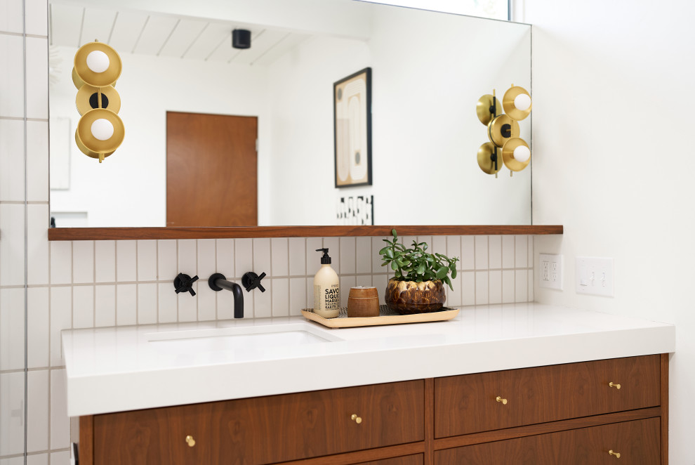This is an example of a mid-sized midcentury master bathroom in Orange County with flat-panel cabinets, dark wood cabinets, a freestanding tub, a corner shower, a two-piece toilet, white tile, ceramic tile, white walls, terrazzo floors, an undermount sink, engineered quartz benchtops, beige floor, a hinged shower door, white benchtops, a niche, a single vanity, a floating vanity and wood.