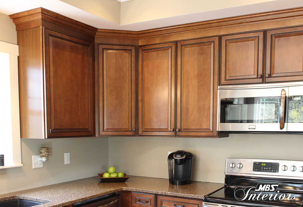 Example of a transitional l-shaped kitchen design in Columbus with an undermount sink, recessed-panel cabinets, medium tone wood cabinets, quartz countertops, stainless steel appliances and an island