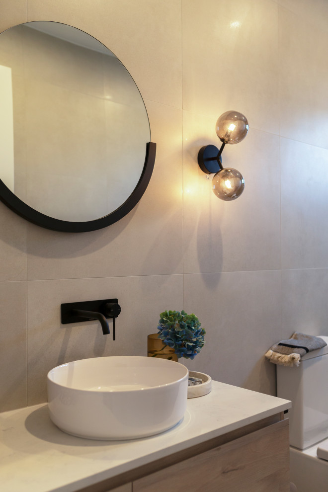 Photo of a mid-sized modern master bathroom in Canberra - Queanbeyan with furniture-like cabinets, white cabinets, an open shower, a one-piece toilet, gray tile, porcelain tile, grey walls, porcelain floors, a vessel sink, engineered quartz benchtops, grey floor, an open shower and white benchtops.