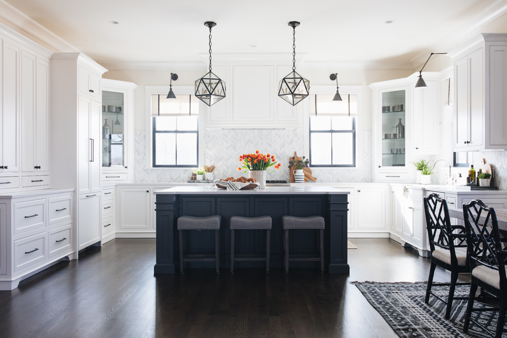 Inspiration for a transitional u-shaped eat-in kitchen in Chicago with an undermount sink, recessed-panel cabinets, white cabinets, grey splashback, marble splashback, panelled appliances, dark hardwood floors, with island and brown floor.