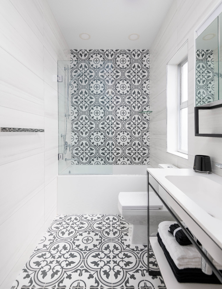 Inspiration for a mid-sized contemporary master bathroom in Vancouver with black cabinets, an alcove tub, a shower/bathtub combo, a one-piece toilet, white tile, porcelain tile, black walls, porcelain floors, an integrated sink, engineered quartz benchtops, black floor, a hinged shower door, white benchtops and open cabinets.
