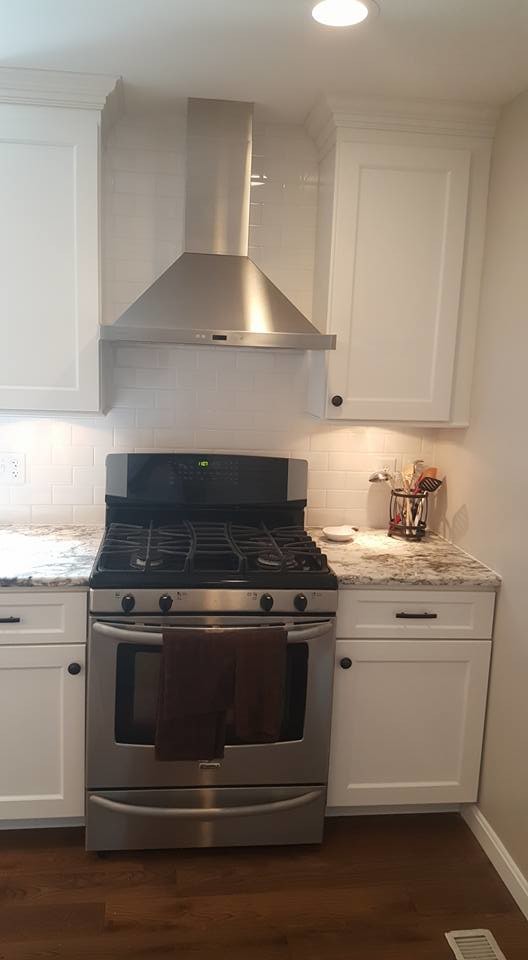 Inspiration for a large transitional u-shaped dark wood floor eat-in kitchen remodel in Baltimore with shaker cabinets, white cabinets, stainless steel appliances and an island