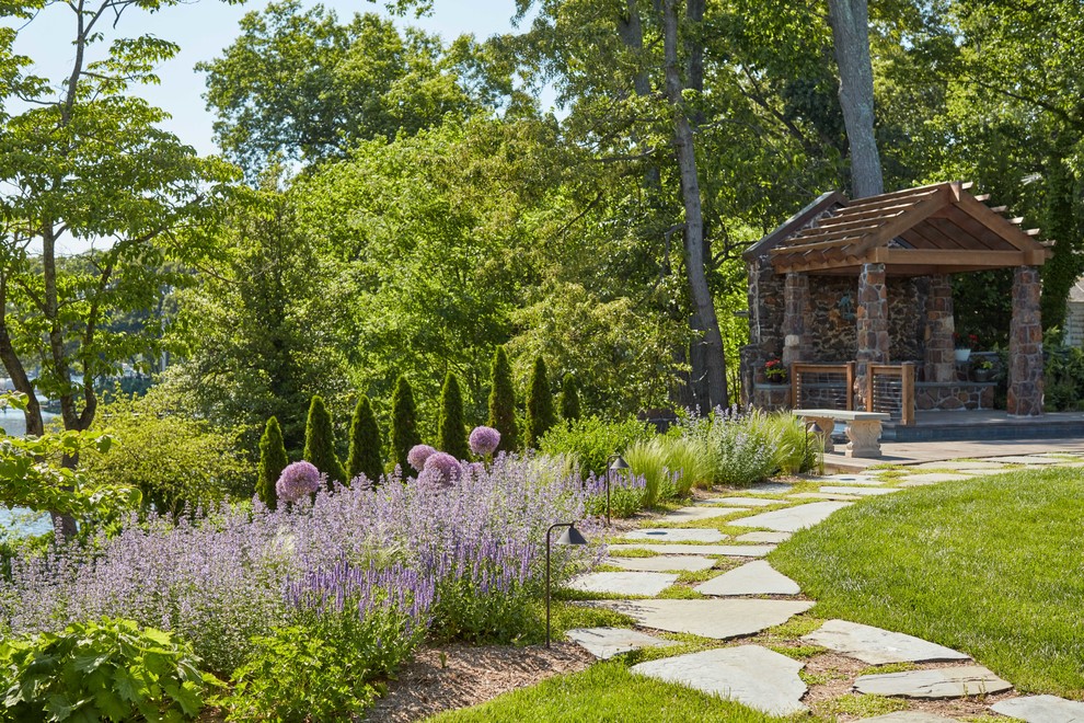 Traditional backyard garden in DC Metro with a garden path and natural stone pavers.