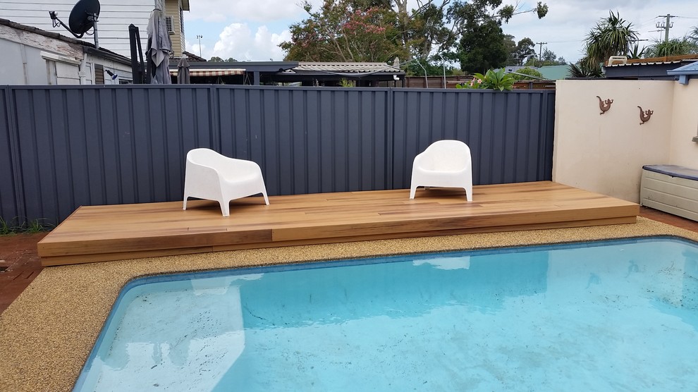 Design ideas for a small modern backyard pool in Sydney with decking.