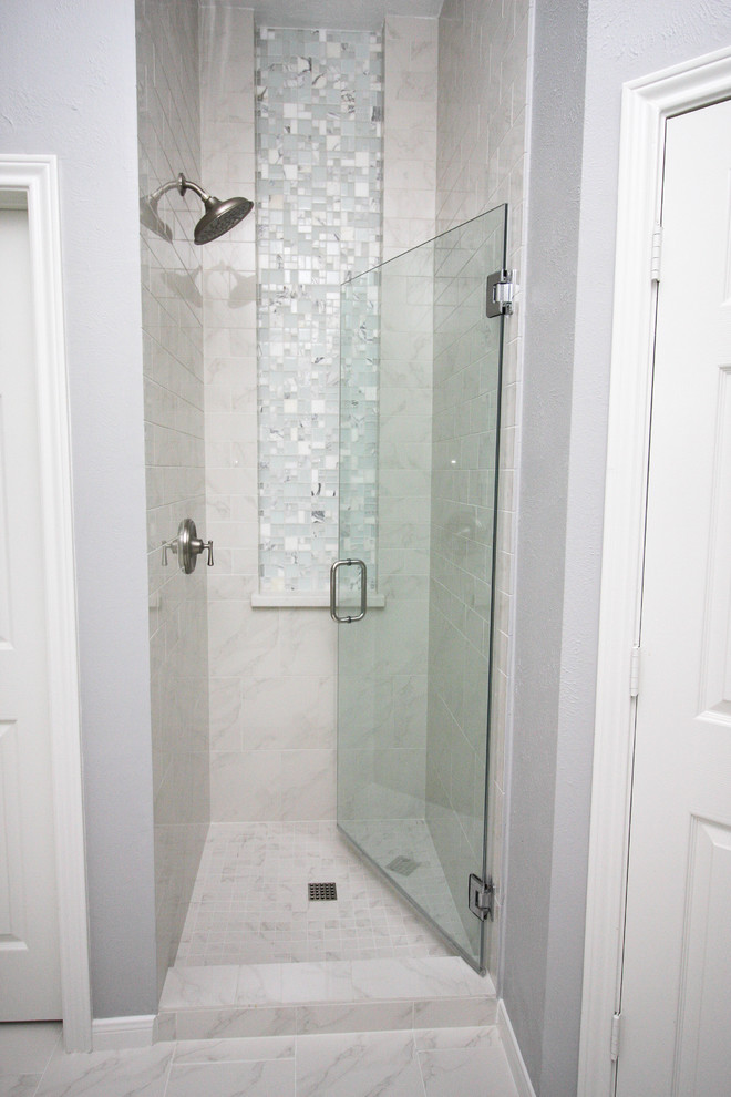 Photo of a large contemporary master bathroom in Houston with raised-panel cabinets, white cabinets, a claw-foot tub, an alcove shower, white tile, porcelain tile, grey walls, porcelain floors, an undermount sink, engineered quartz benchtops, white floor and a hinged shower door.