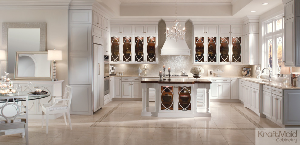 Inspiration for a mid-sized transitional u-shaped eat-in kitchen in Detroit with raised-panel cabinets, white cabinets, stainless steel appliances and with island.