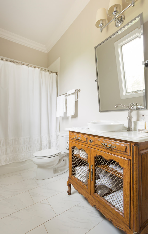 Inspiration for a mid-sized traditional bathroom in Little Rock with furniture-like cabinets, white cabinets, a drop-in tub, a corner shower, white tile, ceramic tile, grey walls, ceramic floors, a vessel sink and marble benchtops.