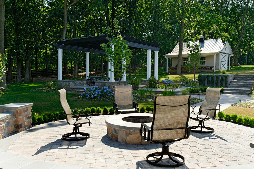 Photo of a traditional patio in DC Metro with a fire feature and a gazebo/cabana.