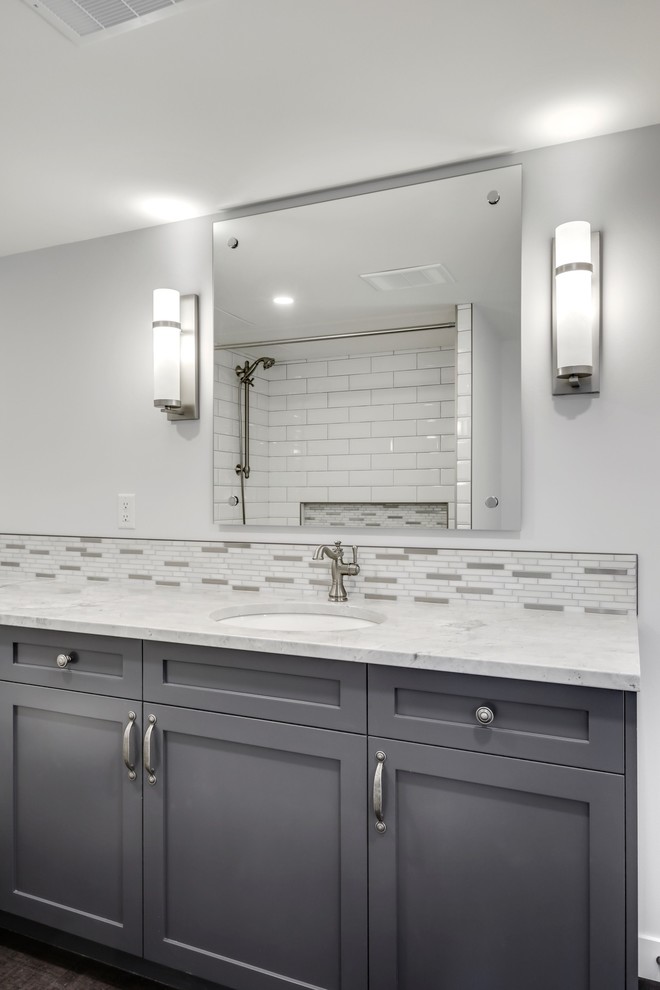 Small transitional master bathroom in Calgary with shaker cabinets, brown cabinets, a drop-in tub, a shower/bathtub combo, a two-piece toilet, multi-coloured tile, mosaic tile, grey walls, cork floors, an undermount sink, quartzite benchtops, brown floor, a shower curtain and white benchtops.