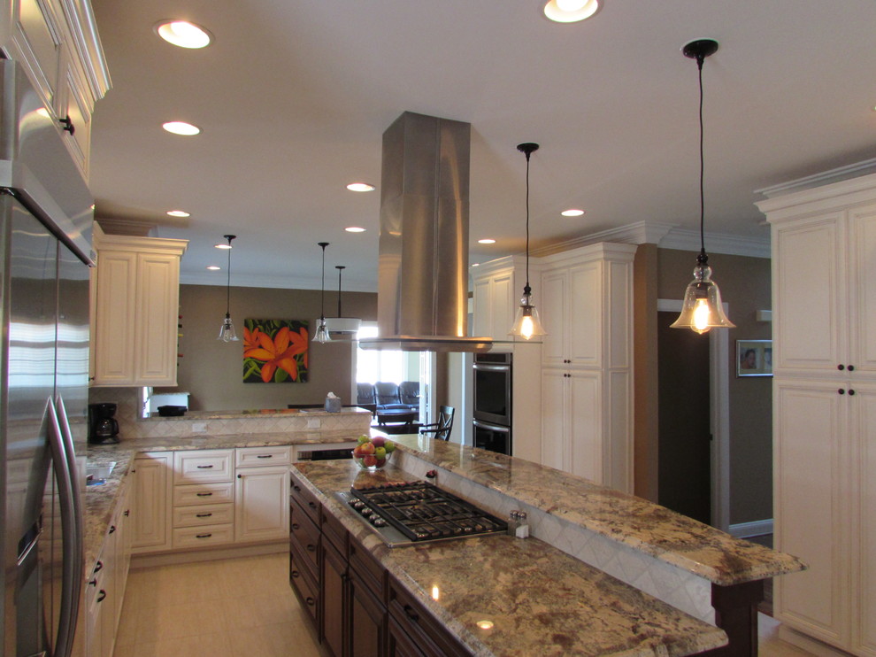 Example of a large transitional l-shaped ceramic tile eat-in kitchen design in DC Metro with an undermount sink, raised-panel cabinets, white cabinets, granite countertops, beige backsplash, ceramic backsplash, stainless steel appliances and an island