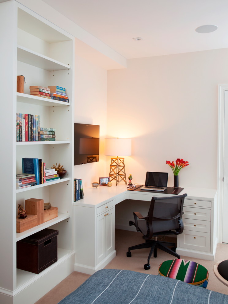 Inspiration for a mid-sized traditional home office in New York with white walls and carpet.