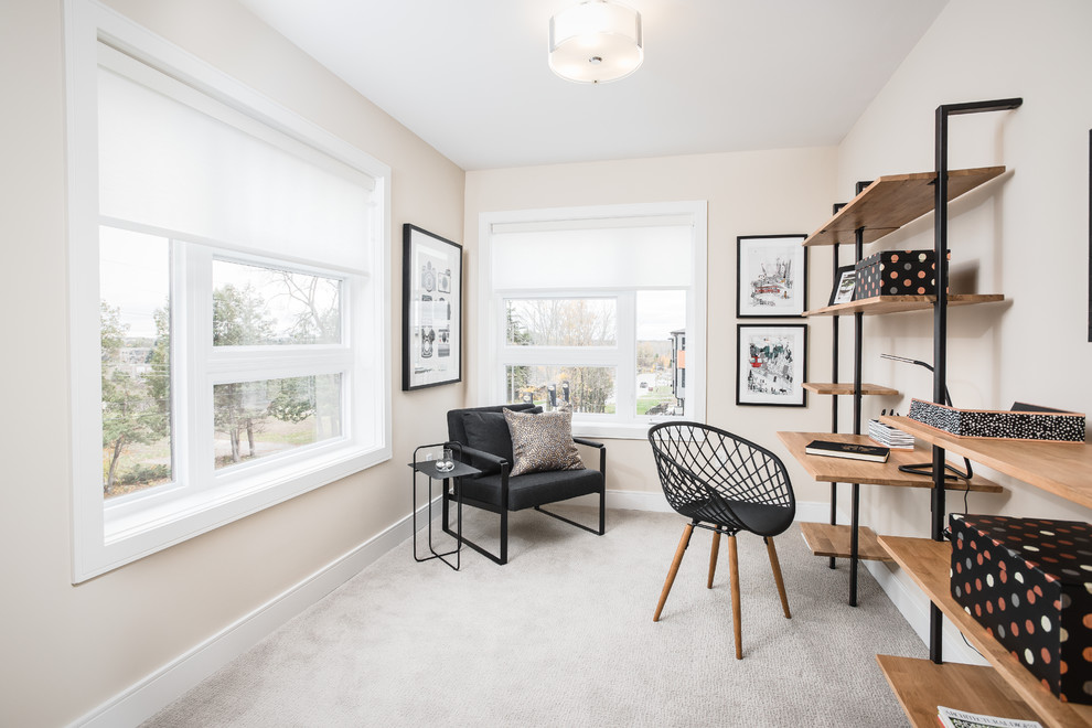 Inspiration for a small modern home office in Toronto with beige walls and carpet.