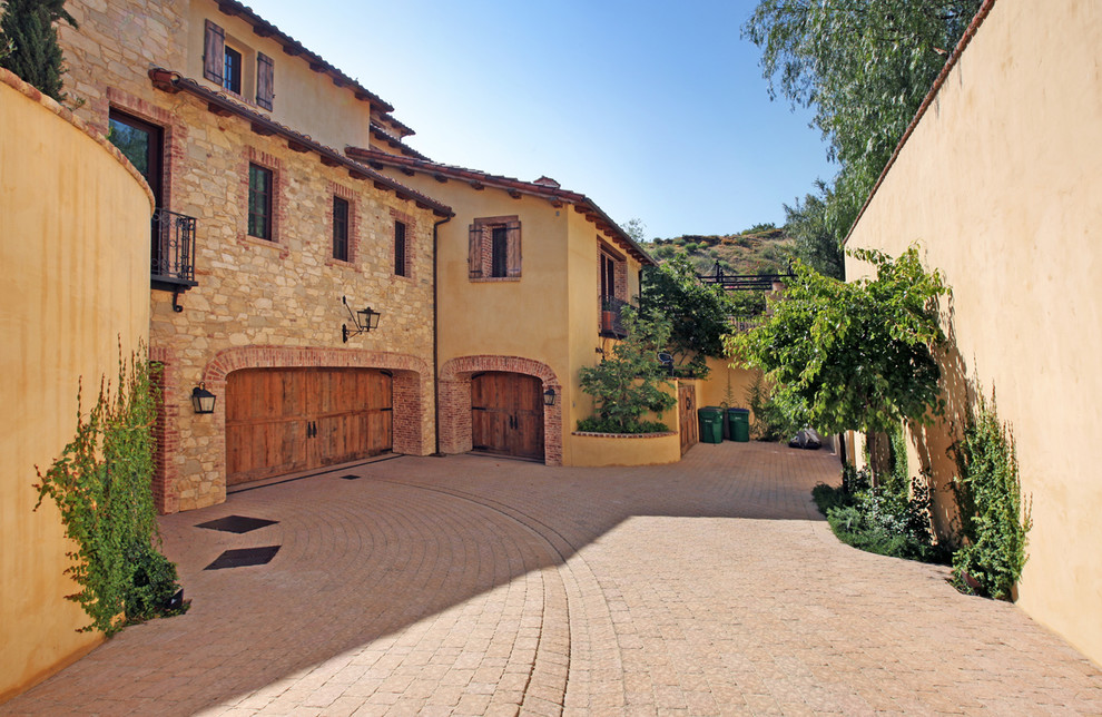Photo of a mediterranean three-storey exterior in Orange County with a shed roof.