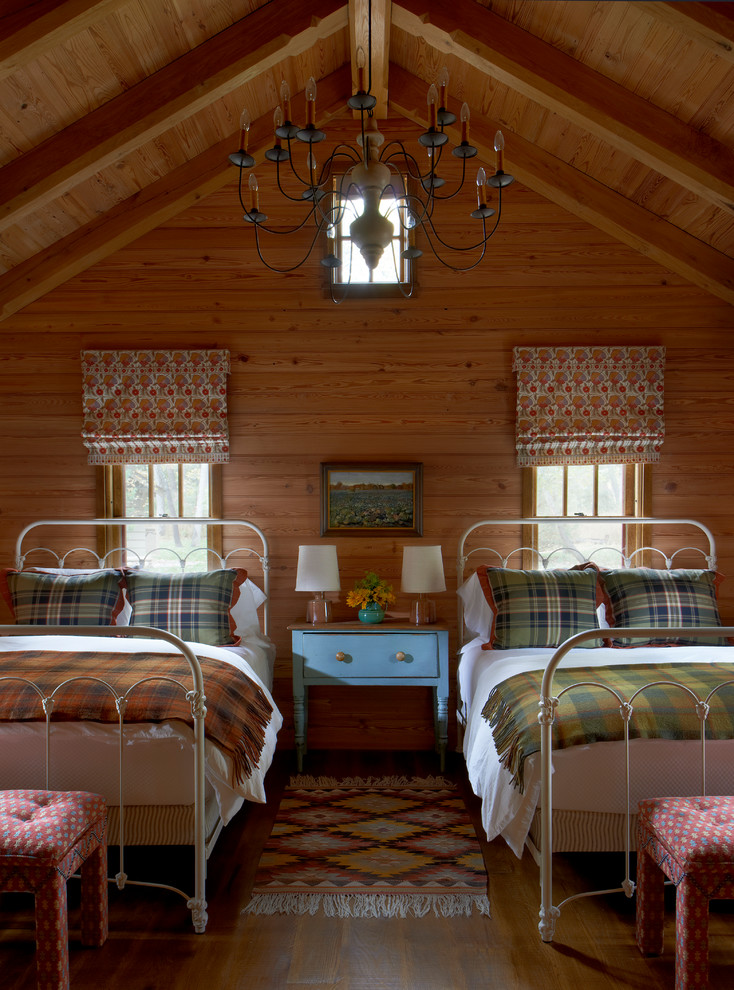 This is an example of a country guest bedroom in Chicago with medium hardwood floors.