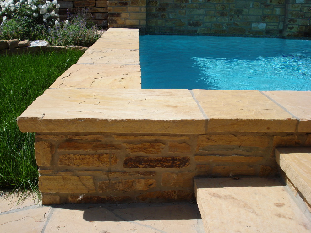 This is an example of a mid-sized mediterranean backyard l-shaped aboveground pool in San Francisco with a water feature and natural stone pavers.