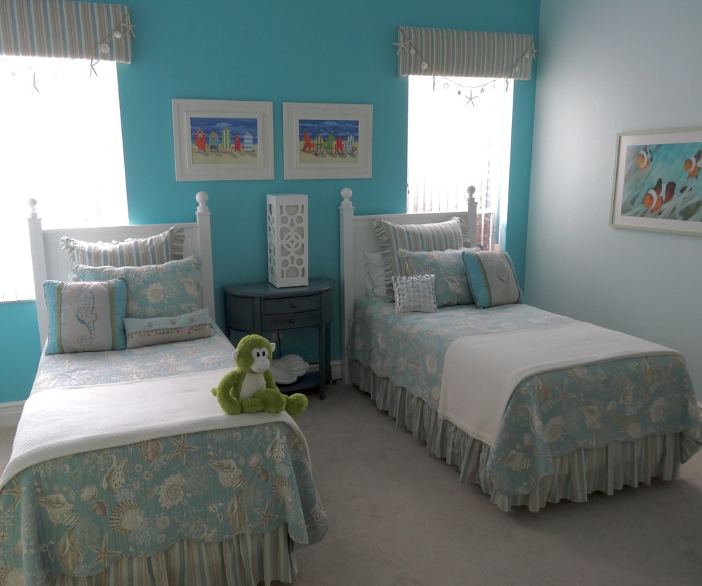 This is an example of a large traditional gender-neutral kids' bedroom for kids 4-10 years old in Orange County with blue walls and carpet.
