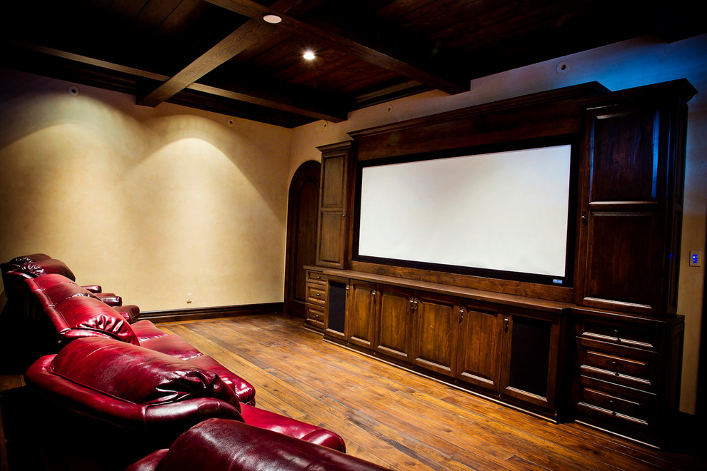 Photo of a country home theatre in Other with beige walls and medium hardwood floors.