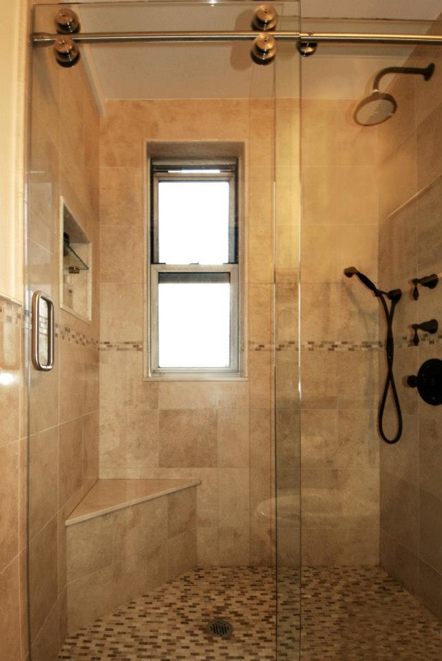 This is an example of a mid-sized traditional master bathroom in New York with brown tile, ceramic tile, brown walls, ceramic floors, brown floor, a sliding shower screen, flat-panel cabinets, brown cabinets, engineered quartz benchtops and brown benchtops.