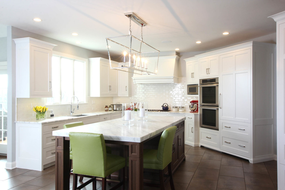 Inspiration for a mid-sized transitional u-shaped eat-in kitchen in Philadelphia with an undermount sink, beaded inset cabinets, white cabinets, marble benchtops, white splashback, ceramic splashback, stainless steel appliances and porcelain floors.