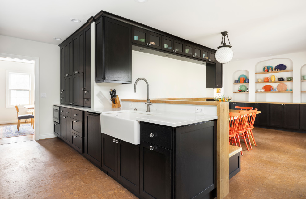 Design ideas for a large galley eat-in kitchen in Portland with a farmhouse sink, shaker cabinets, black cabinets, quartz benchtops, multi-coloured splashback, terra-cotta splashback, black appliances, cork floors, no island, brown floor and white benchtop.
