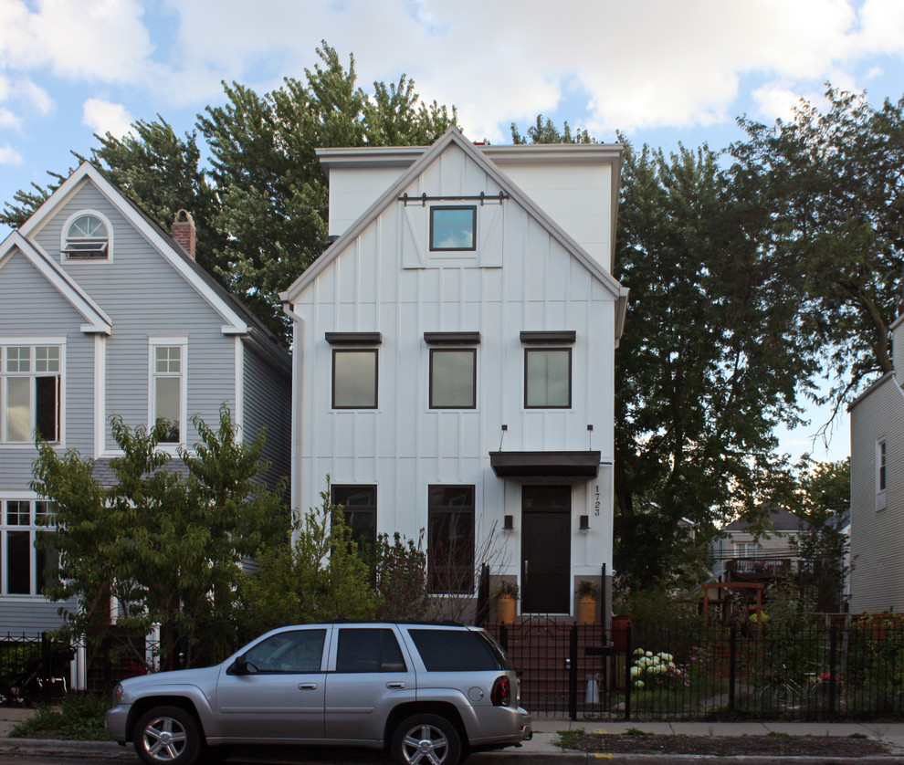 Country three-storey white exterior in Chicago with concrete fiberboard siding.