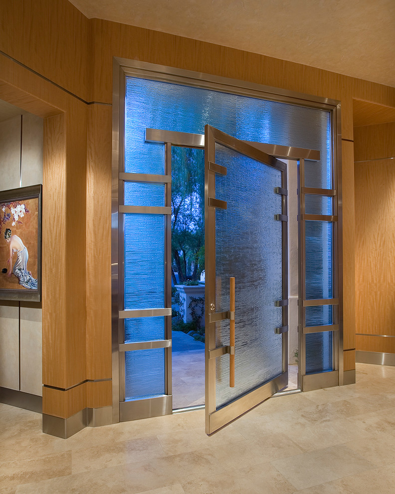 This is an example of an asian entryway in Phoenix with a pivot front door.
