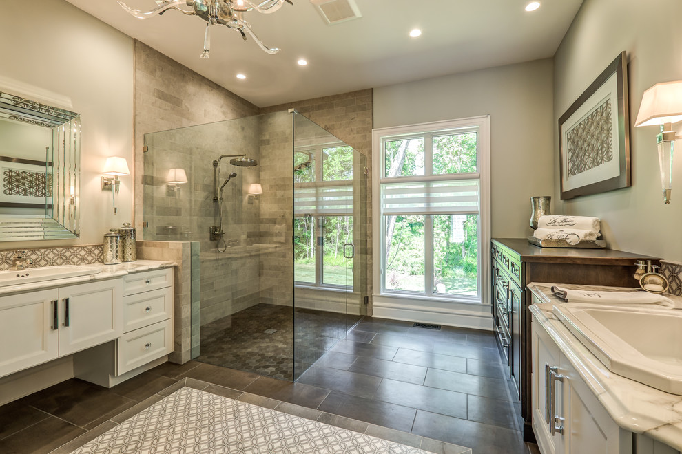 Expansive transitional master bathroom in Other with subway tile, white cabinets, a drop-in sink, a hinged shower door, a corner shower, grey walls, porcelain floors, marble benchtops, brown floor, multi-coloured benchtops and recessed-panel cabinets.