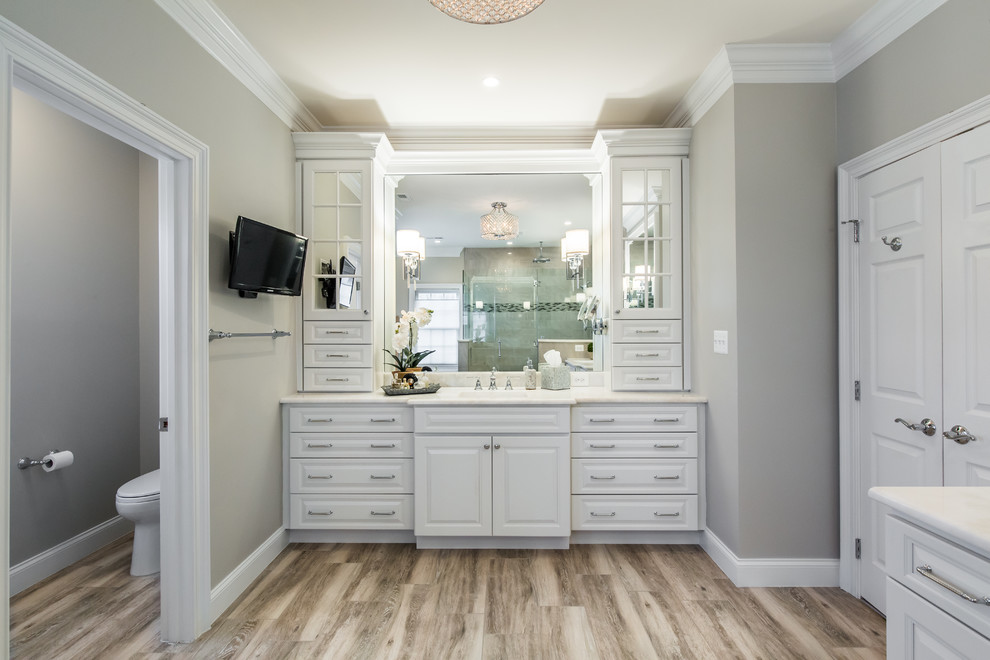 Design ideas for a large transitional master bathroom in DC Metro with raised-panel cabinets, white cabinets, a freestanding tub, a two-piece toilet, multi-coloured tile, porcelain tile, grey walls, porcelain floors, an undermount sink and marble benchtops.