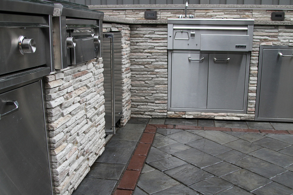 Photo of a mid-sized traditional backyard patio in Boston with an outdoor kitchen, concrete pavers and no cover.