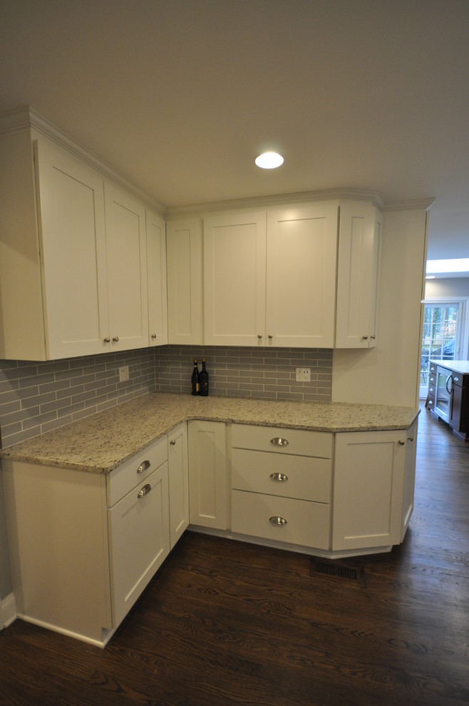 Eat-in kitchen - large transitional u-shaped dark wood floor and brown floor eat-in kitchen idea in DC Metro with an undermount sink, shaker cabinets, white cabinets, green backsplash, subway tile backsplash, stainless steel appliances and an island