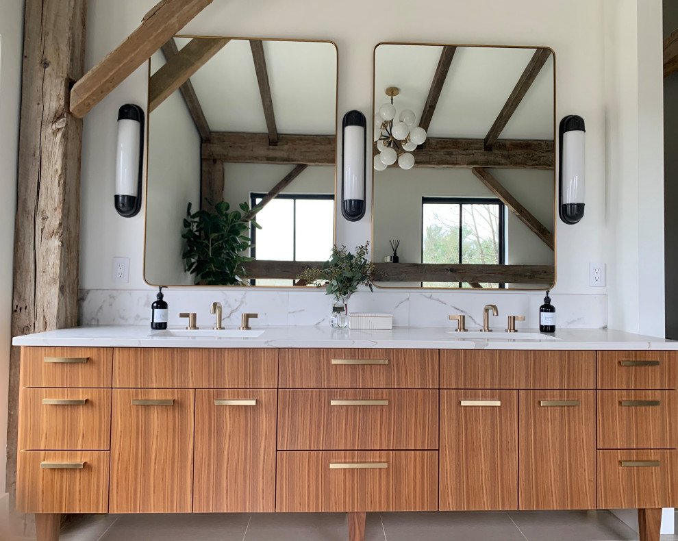 Photo of a large modern master bathroom in Cleveland with flat-panel cabinets, medium wood cabinets, a freestanding tub, an alcove shower, white walls, porcelain floors, an undermount sink, quartzite benchtops, white floor, a hinged shower door, white benchtops, an enclosed toilet, a double vanity, a freestanding vanity and exposed beam.