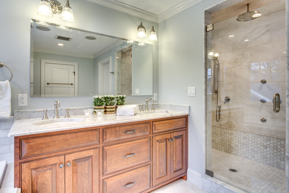 Design ideas for a mid-sized traditional master bathroom in Boston with an undermount sink, raised-panel cabinets, medium wood cabinets, marble benchtops, grey walls, porcelain floors, a corner shower, a two-piece toilet, gray tile, an alcove tub and a hinged shower door.