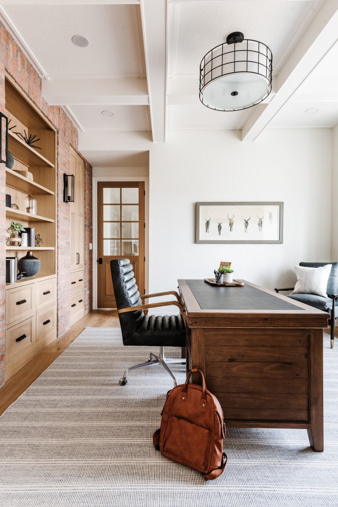 Inspiration for a transitional home office in Salt Lake City with white walls, medium hardwood floors, a freestanding desk, brown floor and exposed beam.