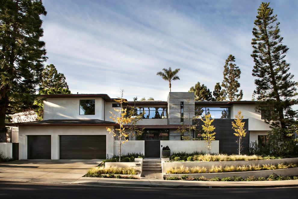 Inspiration for a large contemporary two-storey white exterior in Orange County with mixed siding and a hip roof.