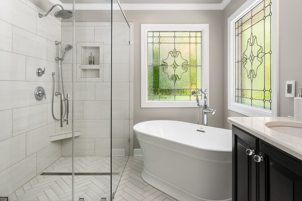 Inspiration for a transitional master beige floor and single-sink freestanding bathtub remodel with raised-panel cabinets, black cabinets, beige walls, quartz countertops, a hinged shower door, beige countertops and a built-in vanity