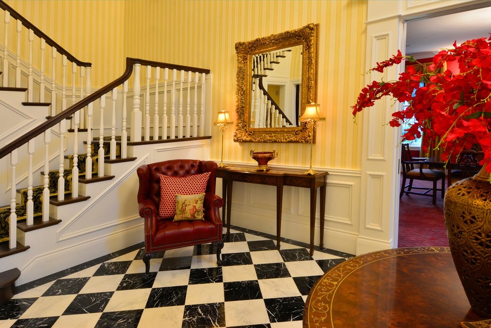 Entry hall - mid-sized transitional marble floor entry hall idea in Seattle with yellow walls