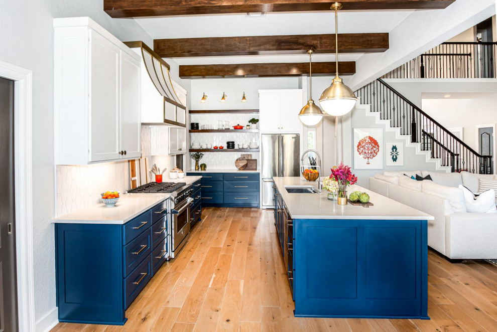 Transitional kitchen in Houston with blue cabinets, white splashback, with island and white benchtop.