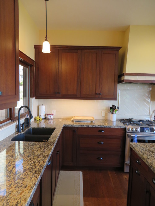 Traditional kitchen with mahogany kitchen cabinets, granite countertops and a black sink